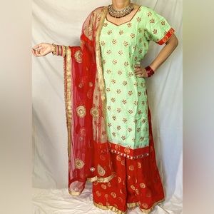Embroidered Indian lehnga with light greenish shirt and red lehnga